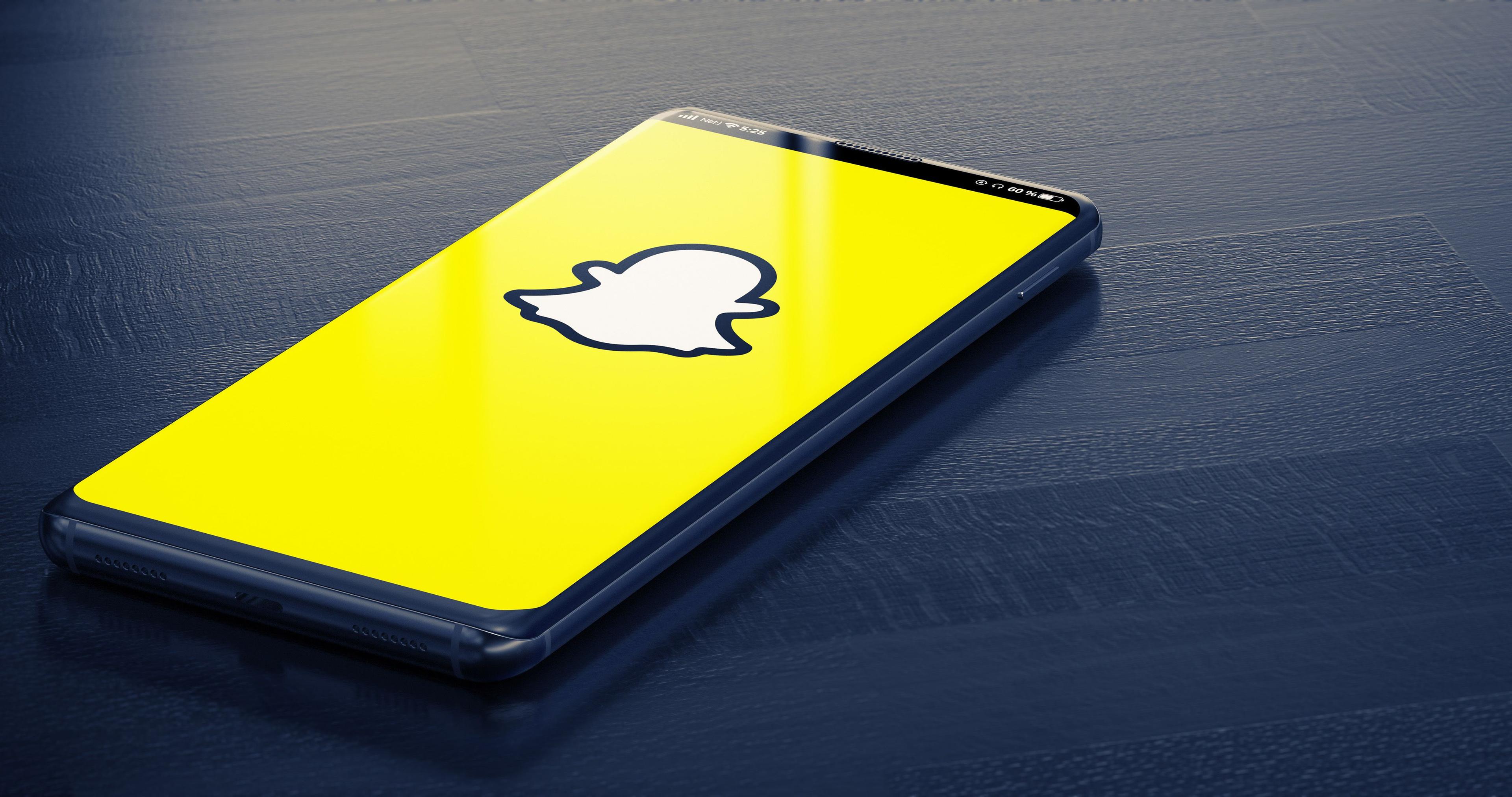 A phone with the snapchat logo on it.